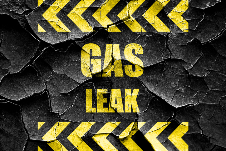 A hazard sign is above and below the words gas leak.